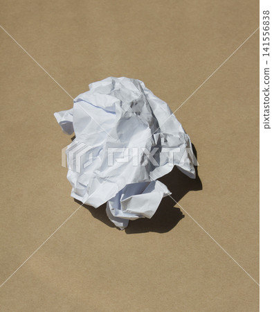 Crumpled paper isolated on brown background . Crumpled paper isolated on brown background . 141556838