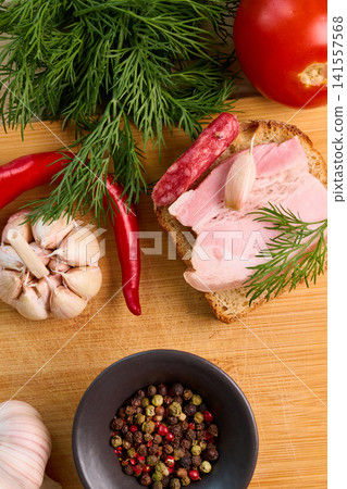 Traditional Ukrainian Snack with Salo, Spices, and Fresh Vegetables Traditional Ukrainian Snack with Salo, Spices, and Fresh Vegetables 141557568