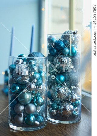 Glass Vases Filled with Blue and Silver Christmas Baubles 141557608