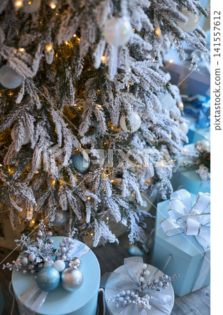 Frosted Christmas Tree and Wrapped Gifts 141557612
