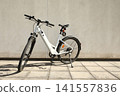 Bicycle isolated on a wall background, with copy space for text 141557836