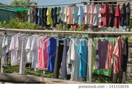 A Kaleidoscope of Market Apparel Drying on the Line. 141558056