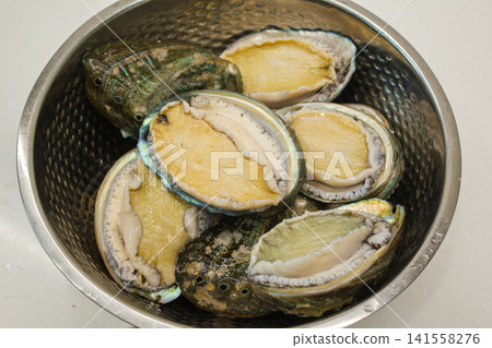 These are abalones in a mixing bowl. These are abalones in a mixing bowl. 141558276