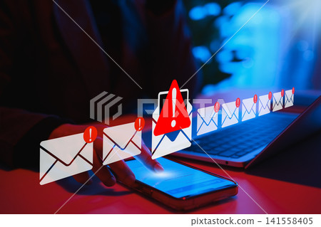 Email security threat notification and spam warning concept. Person using phone with warning and email symbol, cybersecurity threat, phishing attack, spam risk in online communication, data protection Email security threat notification and spam warning concept. Person using phone with warning and email symbol, cybersecurity threat, phishing attack, spam risk in online communication, data protection 141558405