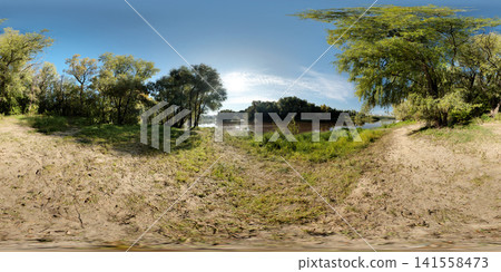 Panoramic riverside sandy bank with autumn deciduous trees, calm reflective water, clear blue sky and warm golden hour light across peaceful landscape, with river, sandy, bank, HDRI 360 panorama Panoramic riverside sandy bank with autumn deciduous trees, calm reflective water, clear blue sky and warm golden hour light across peaceful landscape, with river, sandy, bank, HDRI 360 panorama 141558473