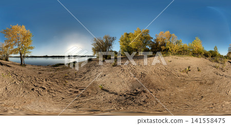 Panoramic riverside sandy bank with autumn deciduous trees, calm reflective water, clear blue sky and warm golden hour light across peaceful landscape, with river, sandy, bank, HDRI 360 panorama Panoramic riverside sandy bank with autumn deciduous trees, calm reflective water, clear blue sky and warm golden hour light across peaceful landscape, with river, sandy, bank, HDRI 360 panorama 141558475