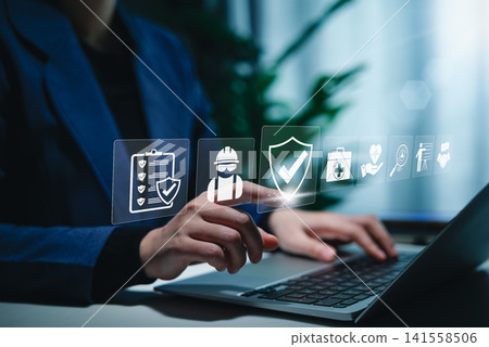 Work safety and compliance concept. A person using a laptop with digital icons representing work safety, compliance, regulations, and professional standards, symbolizing secure workplace practices. 141558506