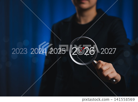 2026 Business Goals and Future Planning Concept. Person holding magnifying glass highlighting the year 2026 with target icon, representing strategic planning, goal setting, business vision for future, 2026 Business Goals and Future Planning Concept. Person holding magnifying glass highlighting the year 2026 with target icon, representing strategic planning, goal setting, business vision for future, 141558569