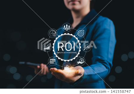 Analyzing ROI and Business Strategy Concepts. Businessperson holding digital icon representing ROI, financial strategies, return on investment, and efficiency. calculate profit, marketing plan, profit Analyzing ROI and Business Strategy Concepts. Businessperson holding digital icon representing ROI, financial strategies, return on investment, and efficiency. calculate profit, marketing plan, profit 141558747