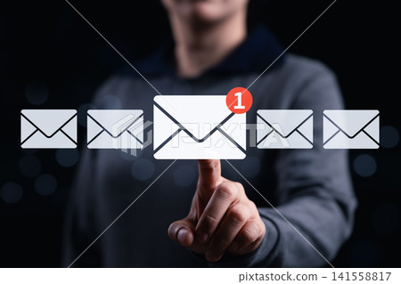 New email notification interaction concept. A woman interacting with a digital interface showing a new email notification symbol, a concept for online communication. E-mail marketing, mail security, New email notification interaction concept. A woman interacting with a digital interface showing a new email notification symbol, a concept for online communication. E-mail marketing, mail security, 141558817