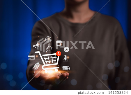 Online Shopping and E-commerce Technology Concept. Woman holding shopping cart icon with ecommerce elements, including delivery, payment, discount, store, modern online shopping, and retail technology Online Shopping and E-commerce Technology Concept. Woman holding shopping cart icon with ecommerce elements, including delivery, payment, discount, store, modern online shopping, and retail technology 141558834