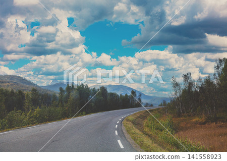 Driving a car on the road on the island of Senja, view from the windshield. Norway, Europe Driving a car on the road on the island of Senja, view from the windshield. Norway, Europe 141558923
