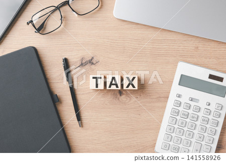 Tax and Accounting Concept.Wooden blocks spelling TAX on wooden desk with calculator, notebook, pen, glasses, and laptop, symbolizing finance, accounting, and taxation. taxes money, financial planning Tax and Accounting Concept.Wooden blocks spelling TAX on wooden desk with calculator, notebook, pen, glasses, and laptop, symbolizing finance, accounting, and taxation. taxes money, financial planning 141558926