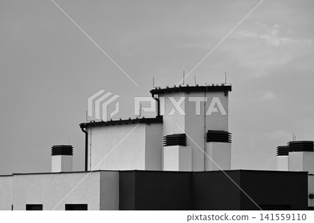 Modern building rooftops against cloudy sky 141559110