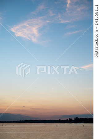 Calm lake at sunset with pink clouds 141559111