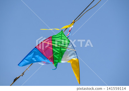 Colorful kite flying in blue sky Colorful kite flying in blue sky 141559114