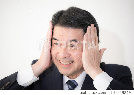 Japanese middle-aged men dyeing their gray hair and styling their hair: A close-up on senior men's grooming and anti-aging care. 141559249