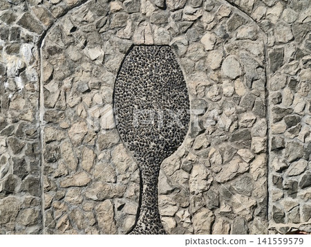 Stone wall with textured goblet relief Stone wall with textured goblet relief 141559579