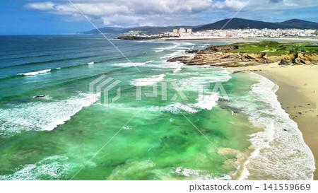 A breathtaking Aerial View showcasing the Stunning Coastal Beach alongside Turquoise Waters 141559669