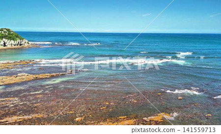 Experience the Serene Beauty of Ocean Waves and Rocky Shoreline Beneath Clear Skies Experience the Serene Beauty of Ocean Waves and Rocky Shoreline Beneath Clear Skies 141559713