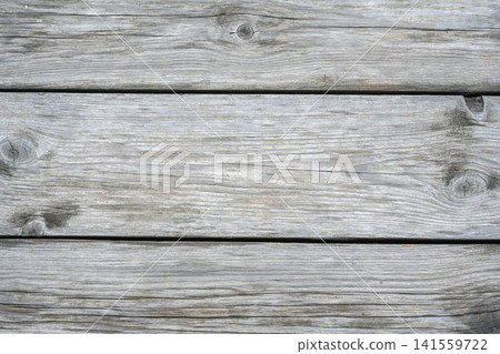 Weathered gray wooden planks background. Rustic aged timber texture with natural grain and knots. Horizontal wood board surface for design. Old paneling backdrop Weathered gray wooden planks background. Rustic aged timber texture with natural grain and knots. Horizontal wood board surface for design. Old paneling backdrop 141559722
