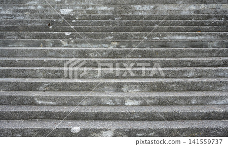 Weathered concrete stairs filling the frame. Close up of empty gray outdoor steps creating a repeating horizontal pattern. Urban architectural texture and background Weathered concrete stairs filling the frame. Close up of empty gray outdoor steps creating a repeating horizontal pattern. Urban architectural texture and background 141559737