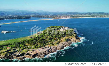 Aerial View of a Scenic Coastal Island Filled with Lush Greenery and Vibrant Nature 141559753