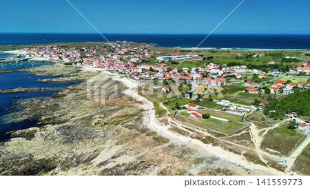 A Beautiful Aerial View of a Coastal Village Surrounded by Tranquil and Calm Waters 141559773