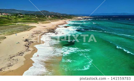 Experience the breathtaking and stunning aerial views of a serene beach with turquoise waters 141559783