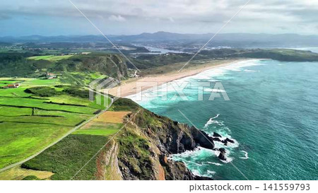 Experience the stunning beauty of lush green fields and turquoise waters along the coast Experience the stunning beauty of lush green fields and turquoise waters along the coast 141559793