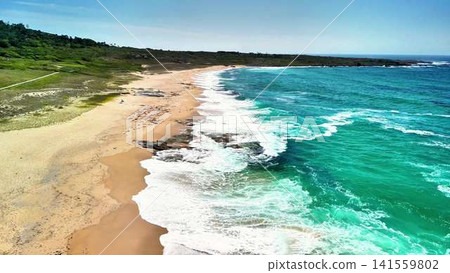 Stunning Aerial View of a Serene Beach Showcasing Turquoise Waters and Lovely Sandy Shores Stunning Aerial View of a Serene Beach Showcasing Turquoise Waters and Lovely Sandy Shores 141559802