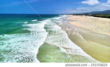 Serene Beach Waves and Golden Sands Stretching Under a Clear Blue Sky of Blissful Relaxation Serene Beach Waves and Golden Sands Stretching Under a Clear Blue Sky of Blissful Relaxation 141559824