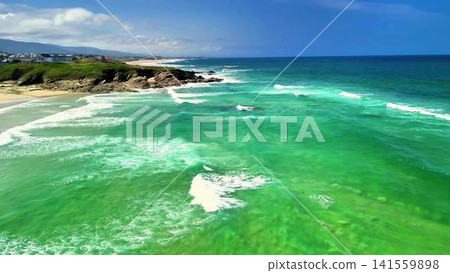 Breathtaking Aerial View of Turquoise Ocean Waves Meeting a Scenic Coastal Landscape Breathtaking Aerial View of Turquoise Ocean Waves Meeting a Scenic Coastal Landscape 141559898