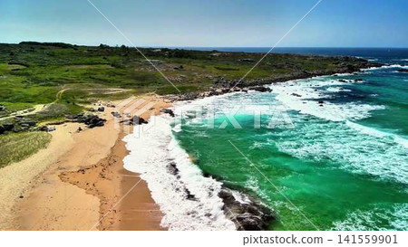 Experience a breathtaking coastal view featuring stunning turquoise waters and a soft sandy beach, 141559901