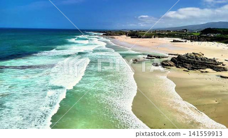 Breathtaking Aerial Perspective of a Peaceful Beach Surrounded by Clear Turquoise Waters Breathtaking Aerial Perspective of a Peaceful Beach Surrounded by Clear Turquoise Waters 141559913