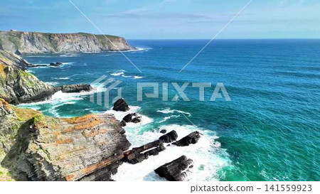 Experience the breathtaking scenic coastal views featuring captivating waves and majestic cliffs Experience the breathtaking scenic coastal views featuring captivating waves and majestic cliffs 141559923
