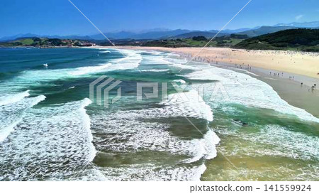 A Scenic Beach View showcasing Waves and Clear Blue Skies over the beautiful coastline A Scenic Beach View showcasing Waves and Clear Blue Skies over the beautiful coastline 141559924
