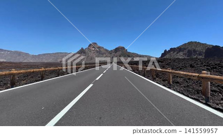 Experience breathtaking volcanic landscapes beneath a clear blue sky stretching across the horizon Experience breathtaking volcanic landscapes beneath a clear blue sky stretching across the horizon 141559957