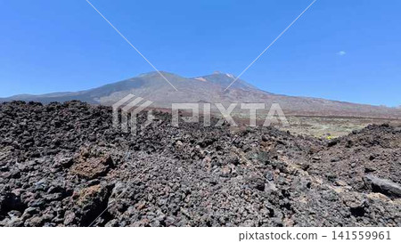 Explore the breathtaking Lava Field and Majestic Volcano Beneath the Clear Blue Sky Explore the breathtaking Lava Field and Majestic Volcano Beneath the Clear Blue Sky 141559961