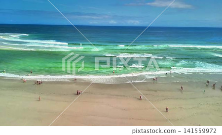 Experience the breathtaking aerial view of a serene beach adorned with beautiful turquoise waters Experience the breathtaking aerial view of a serene beach adorned with beautiful turquoise waters 141559972