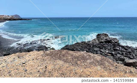 Experience an Amazing Scenic Coastal View with Waves Forcefully Crashing on Rocks Nearby Experience an Amazing Scenic Coastal View with Waves Forcefully Crashing on Rocks Nearby 141559984