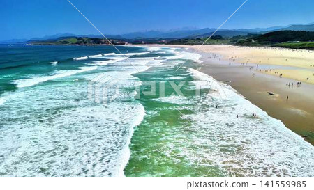 Experience the breathtaking beauty of stunning ocean waves crashing against a sandy beach view Experience the breathtaking beauty of stunning ocean waves crashing against a sandy beach view 141559985