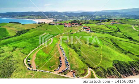 Experience a breathtaking aerial view of lush green hills and a captivating scenic beach Experience a breathtaking aerial view of lush green hills and a captivating scenic beach 141560024