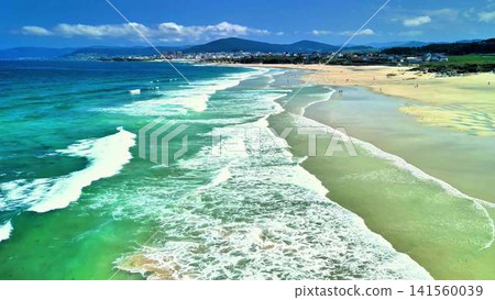 A Stunning Aerial View of a Serene Beach Flanked by Turquoise Waters and a Calm Horizon A Stunning Aerial View of a Serene Beach Flanked by Turquoise Waters and a Calm Horizon 141560039
