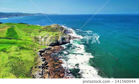 A Stunning Aerial View of a Beautiful Coastal Landscape Featuring Green Hills and a Blue Sea A Stunning Aerial View of a Beautiful Coastal Landscape Featuring Green Hills and a Blue Sea 141560044