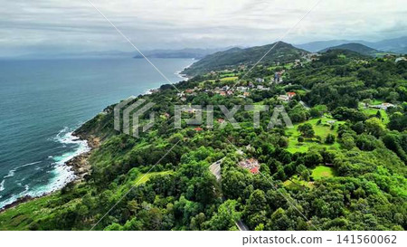 Enjoy the serene coastal views of lush green hills and the stunning crystal blue ocean Enjoy the serene coastal views of lush green hills and the stunning crystal blue ocean 141560062
