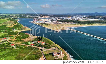 Aerial view of a stunning coastal landscape with a river and its port facilities Aerial view of a stunning coastal landscape with a river and its port facilities 141560114