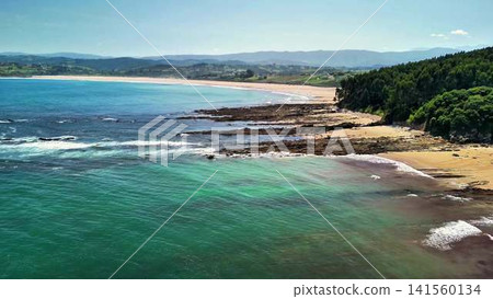 Experience the breathtaking scenic coastal views, featuring clear waters and rugged rocky shores 141560134