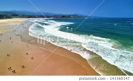 A Stunning Aerial View of a Vibrant Beach Showcasing Waves Crashing Against the Shoreline A Stunning Aerial View of a Vibrant Beach Showcasing Waves Crashing Against the Shoreline 141560147