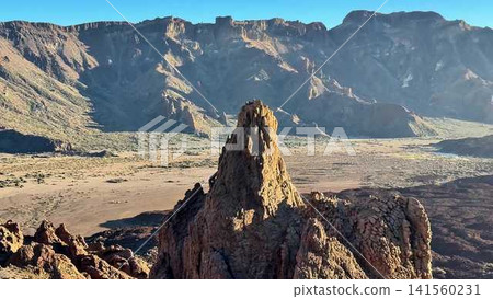 The Majestic Rock Formation Stands Proudly Within the Expansive Desert Landscape The Majestic Rock Formation Stands Proudly Within the Expansive Desert Landscape 141560231